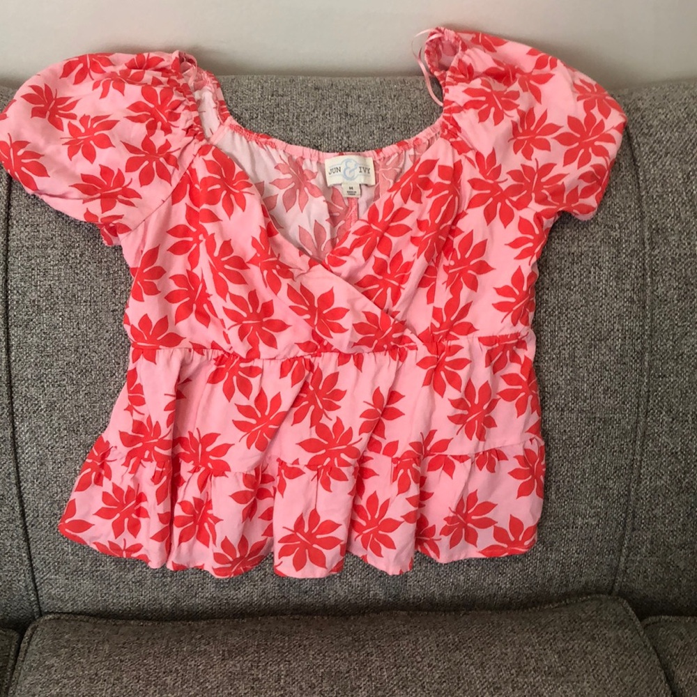 Adorable pink and red top. Pair it with jeans or shorts for a trendy look!